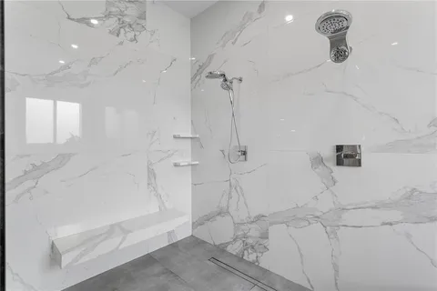 a bathroom with a bathtub and shower