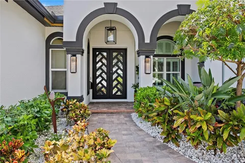 a couple of potted plants next to a building