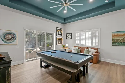 a room with pool table and windows