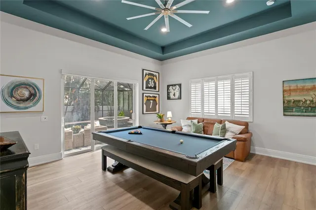 a room with pool table and windows
