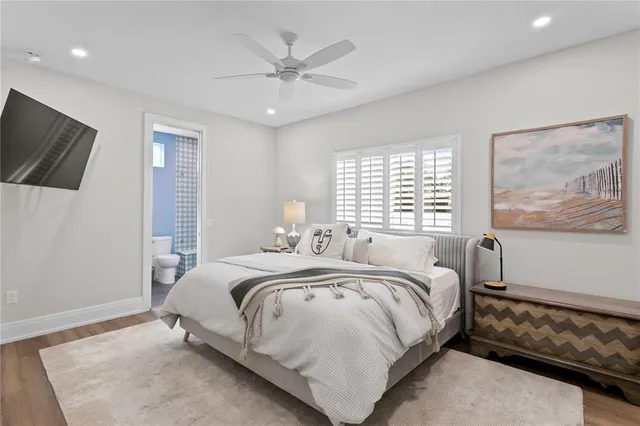 a bed room with a bed a couch and a window