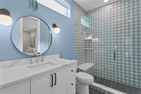 a bathroom with a sink a toilet and a mirror