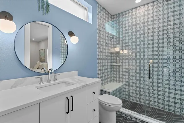 a bathroom with a sink a toilet and a mirror