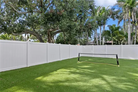 a view of a backyard with a tree