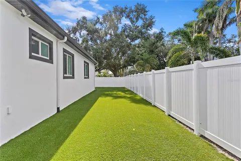 a hallway with a flower pot and a bathroom view