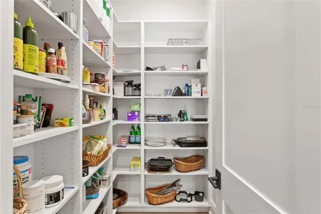 a front view of a house with garden and trees