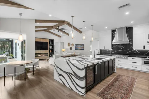 a kitchen with stainless steel appliances granite countertop a stove and a wooden floors