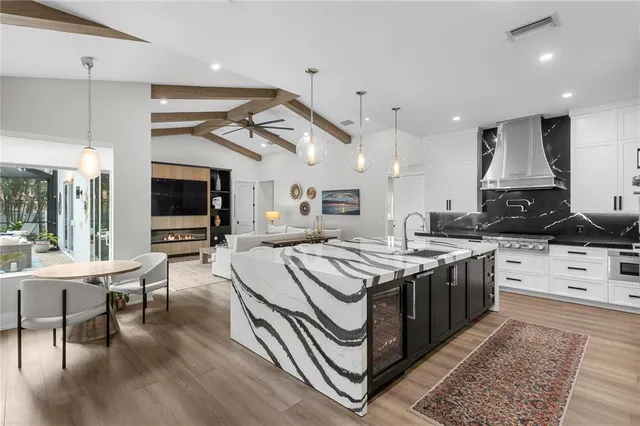 a kitchen with stainless steel appliances granite countertop a stove and a wooden floors