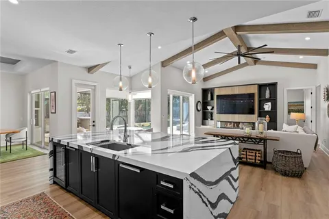 a kitchen with stainless steel appliances granite countertop a sink and cabinets
