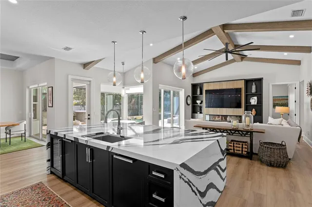 a kitchen with stainless steel appliances granite countertop a sink and cabinets