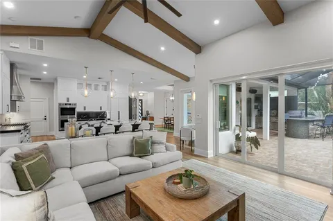 a living room with furniture kitchen and a table