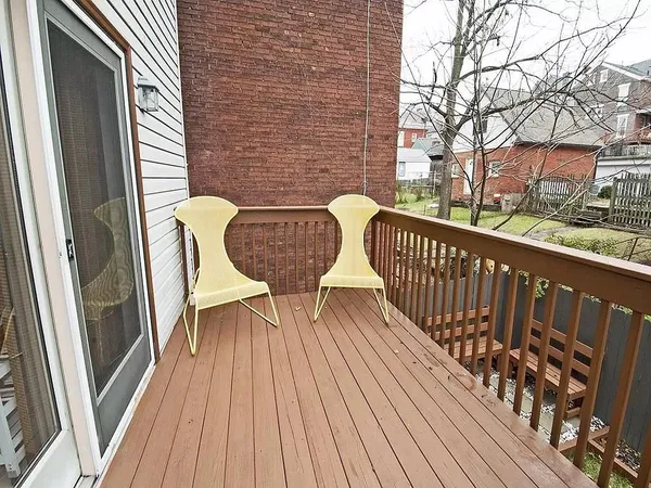 a view of balcony with wooden floor