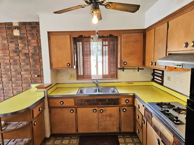 a bathroom with a granite countertop sink and a large mirror