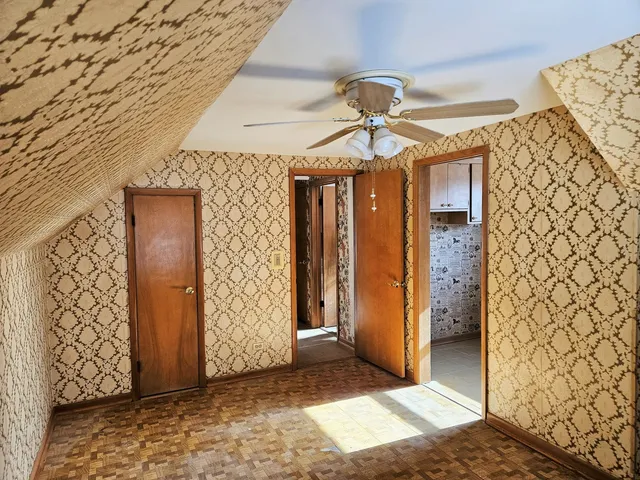 a view of a hallway with wooden walls