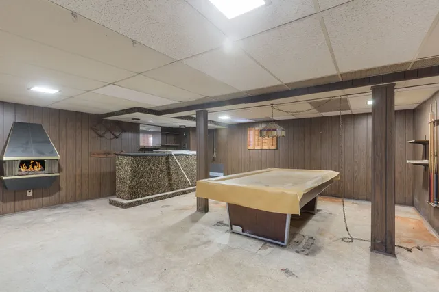 a room with pool table and a couch