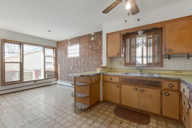 a spacious bathroom with a granite countertop sink mirror and a bathtub