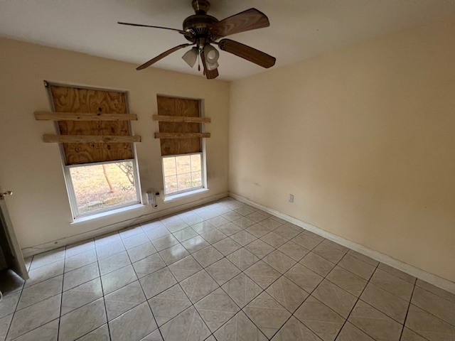 11209 Verano Street Houston, TX 77029 - Photo 9 of 12 an empty room with windows and fan