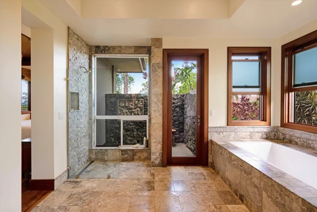 a large spacious bathroom with a large tub and shower