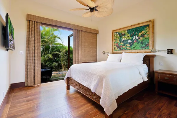 a large bed sitting in a bedroom next to a window