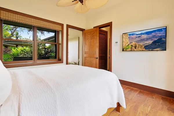 a bedroom with a bed and a large window with outer view