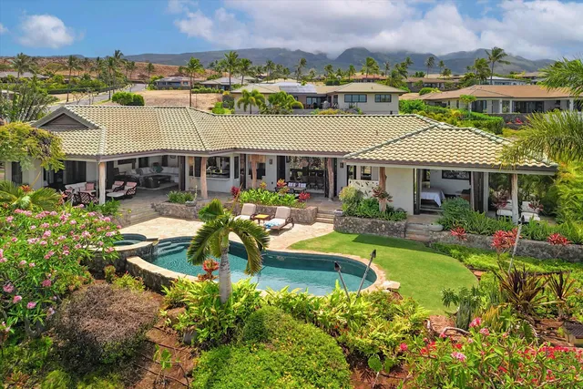 an aerial view of a house with swimming pool garden and patio