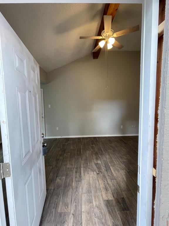a view of an empty room and wooden floor