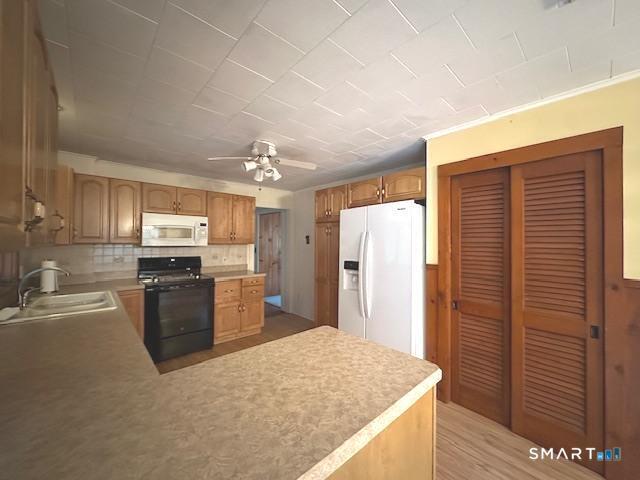 609 Water Street Canterbury, CT 06331 - Photo 5 of 27 a kitchen with refrigerator cabinets and wooden floor