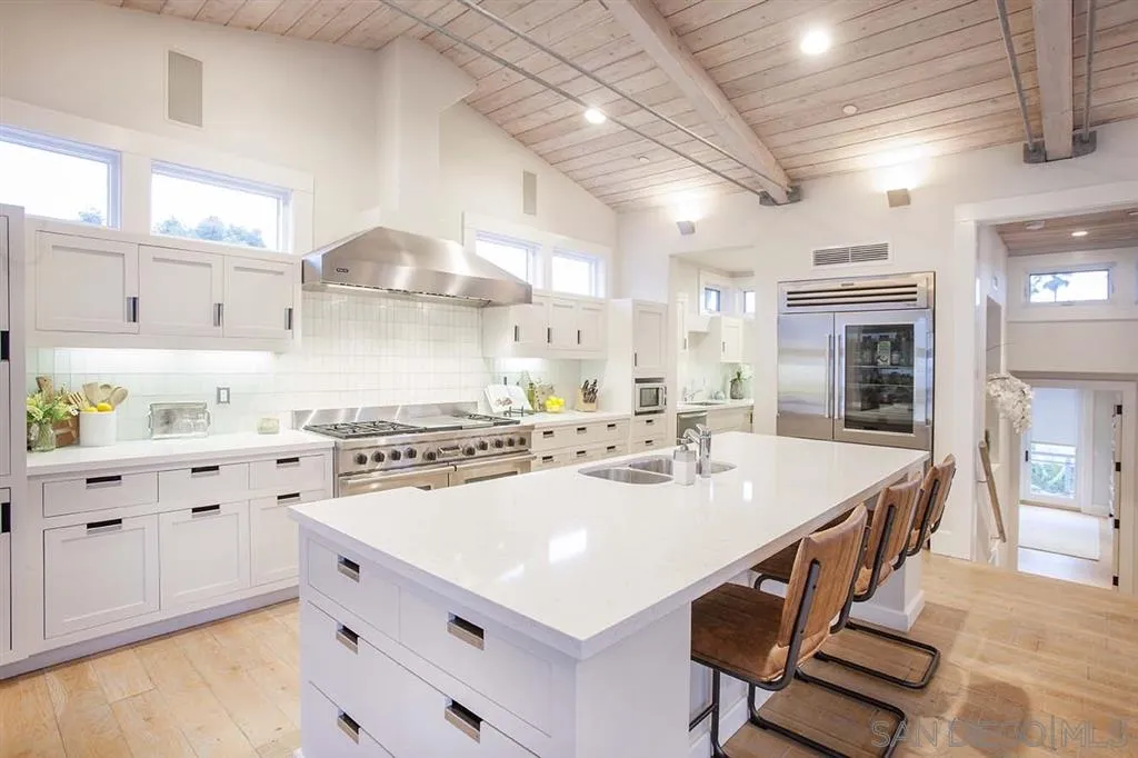 153 5th Street Encinitas, CA 92024 - Photo 12 of 25 a kitchen with a stove a sink and a refrigerator