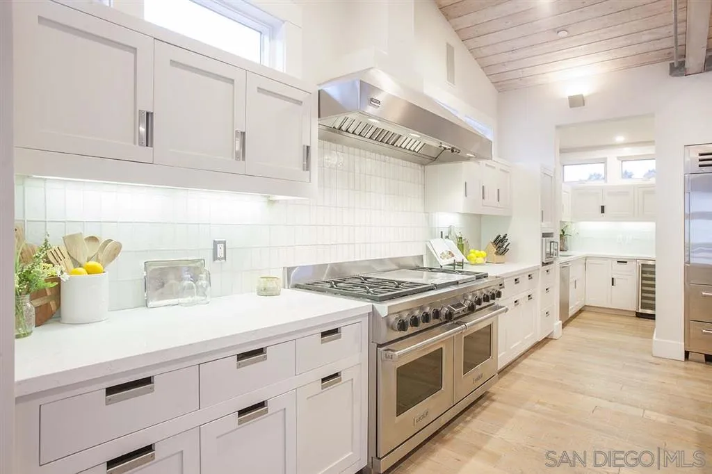 153 5th Street Encinitas, CA 92024 - Photo 13 of 25 a kitchen with stainless steel appliances granite countertop a stove and a sink