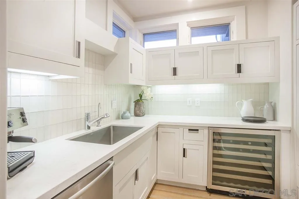 153 5th Street Encinitas, CA 92024 - Photo 14 of 25 a kitchen with cabinets appliances a sink and a counter top space