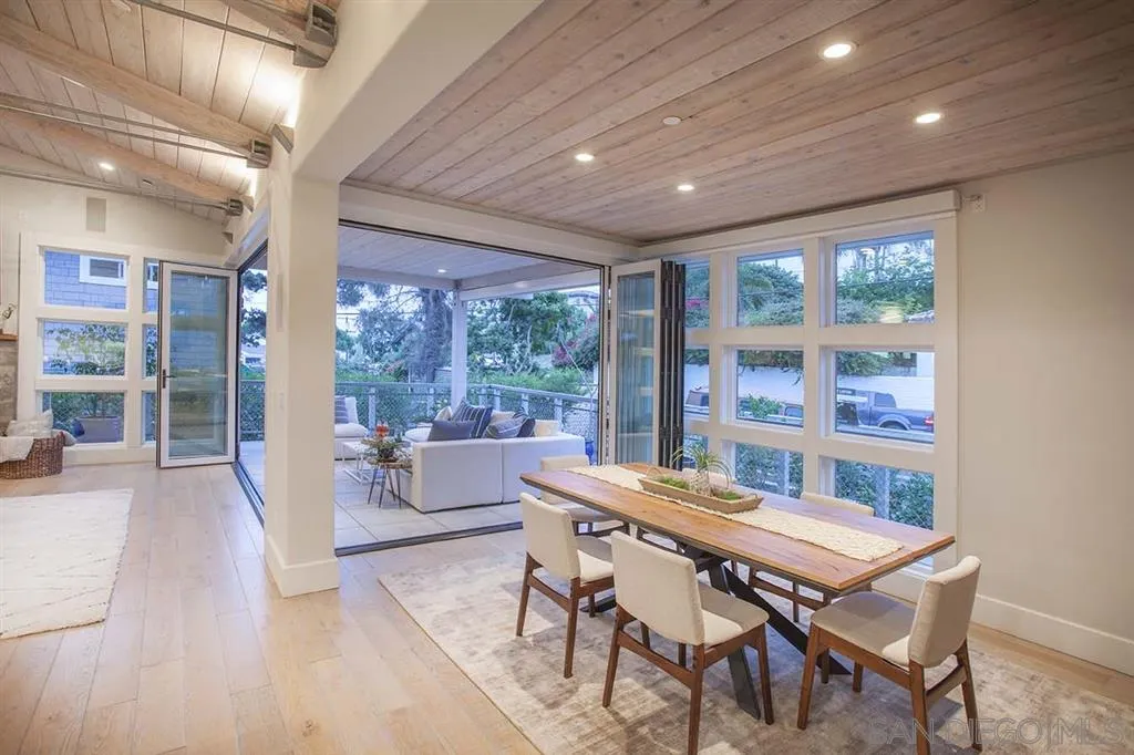 153 5th Street Encinitas, CA 92024 - Photo 15 of 25 a dining room with furniture large windows and wooden floor