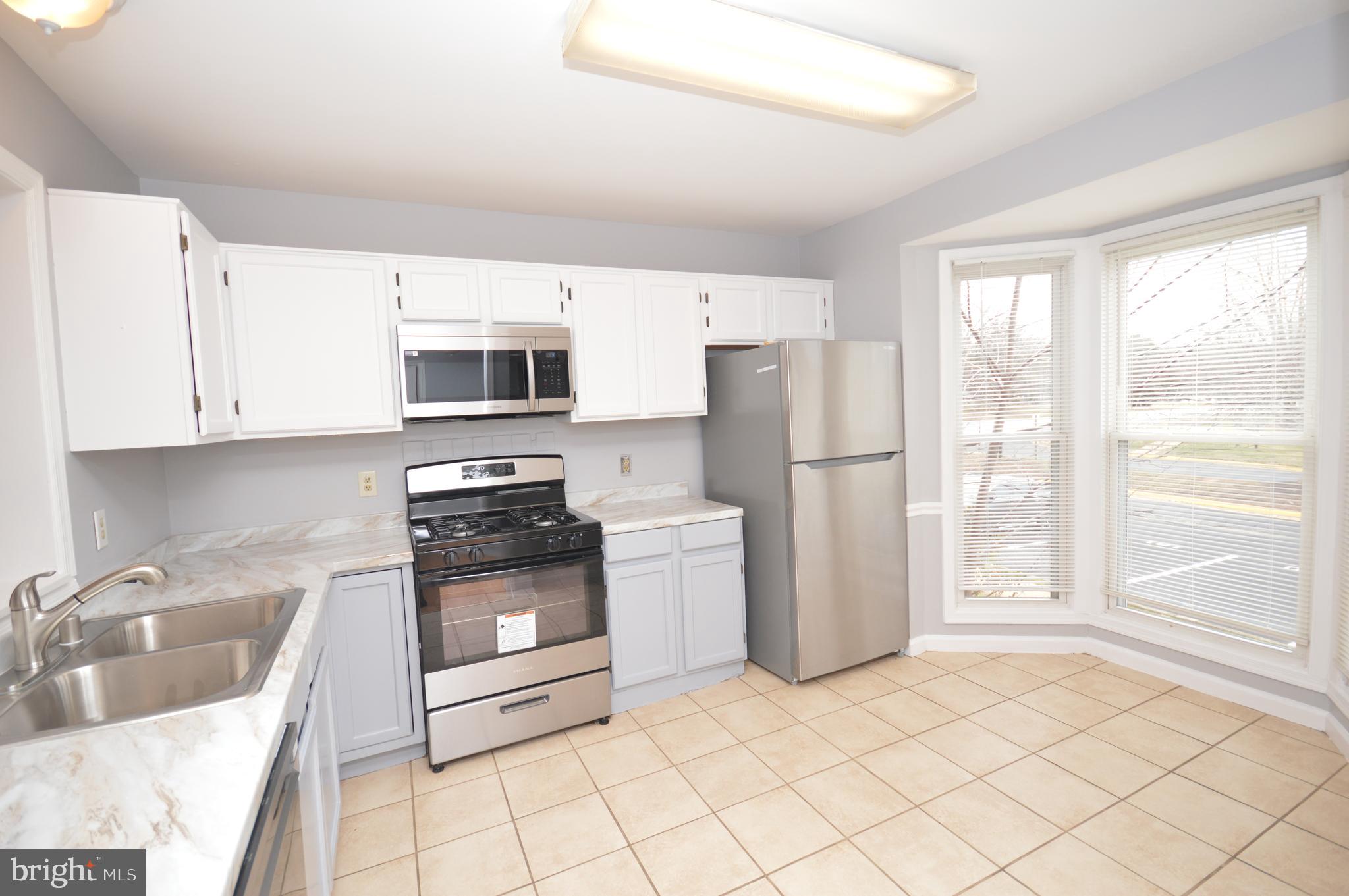 102 Harrogate Road Fredericksburg, VA 22406 - Photo 7 of 41 Kitchen With tile floors and bay window