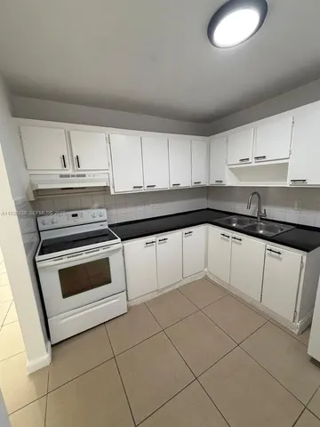 a kitchen with cabinets and appliances