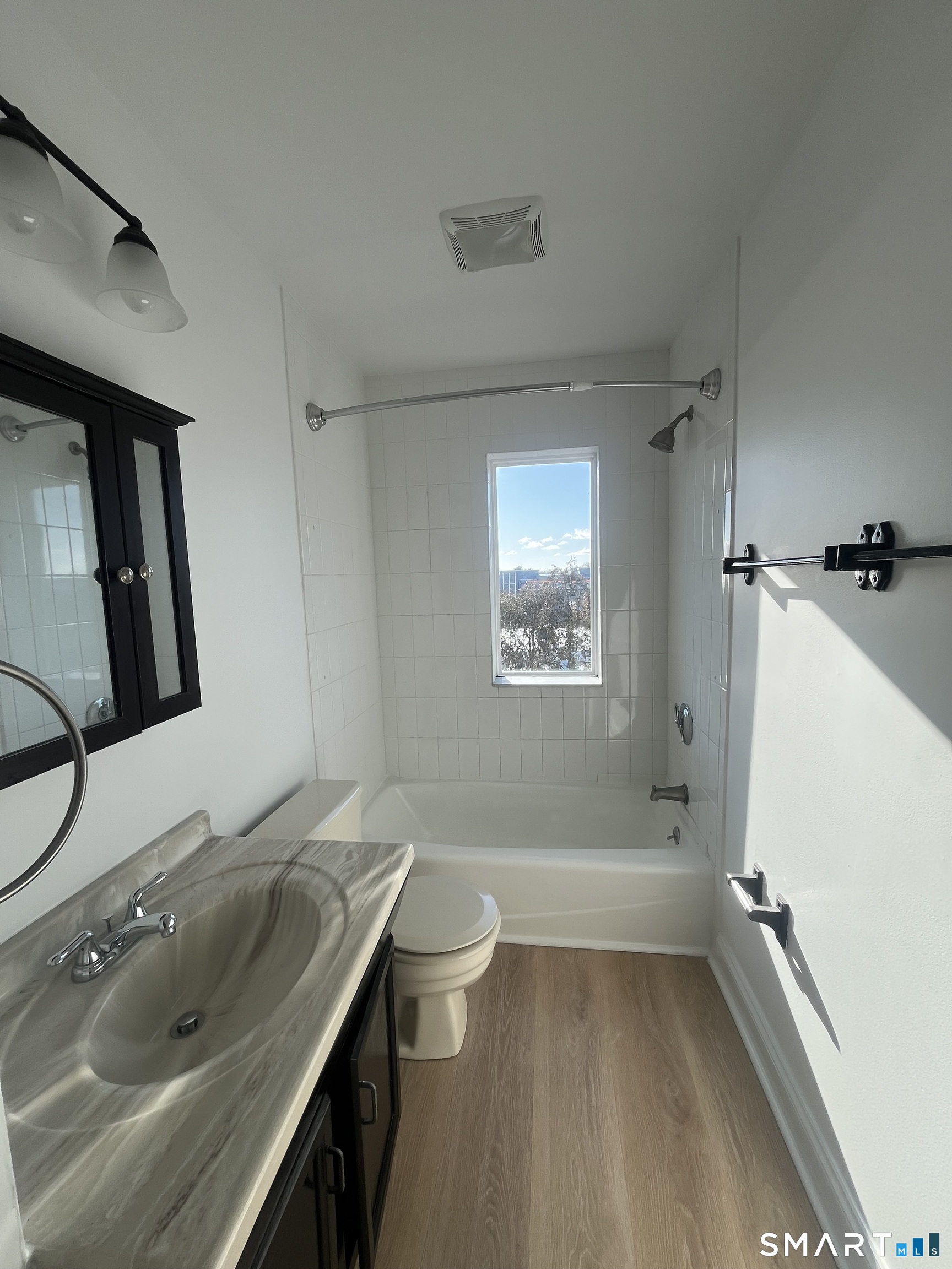31 Stuart Avenue, Unit 12 Norwalk, CT 06850 - Photo 9 of 15 a bathroom with a granite countertop sink toilet and shower