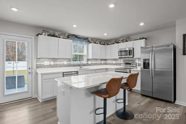 a kitchen with cabinets and stainless steel appliances