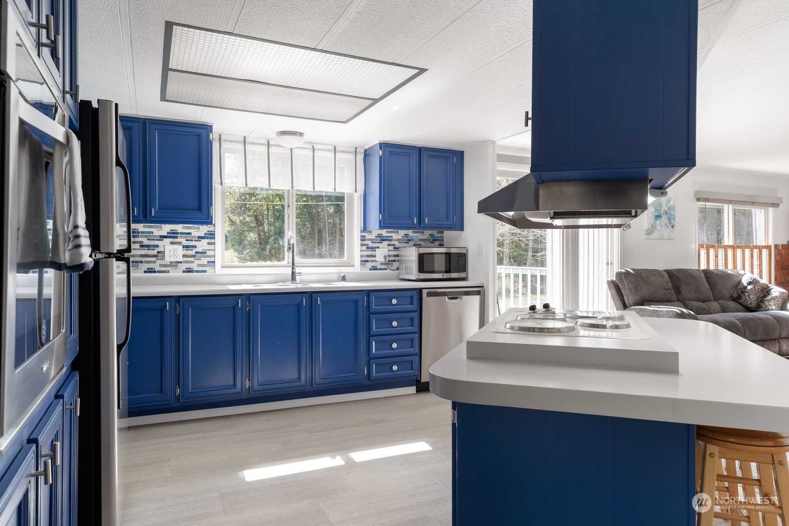1742 Harns Road Oak Harbor, WA 98277 - Photo 11 of 37 a kitchen with kitchen island granite countertop a sink cabinets and window