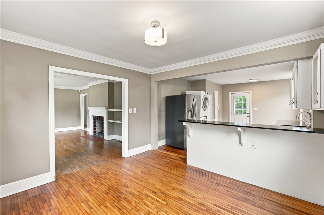 98 Blue Ridge Drive Clemson, SC 29631 - Photo 11 of 32 Rich hardwood floors flow seamlessly from the dining area into an open kitchen setup.