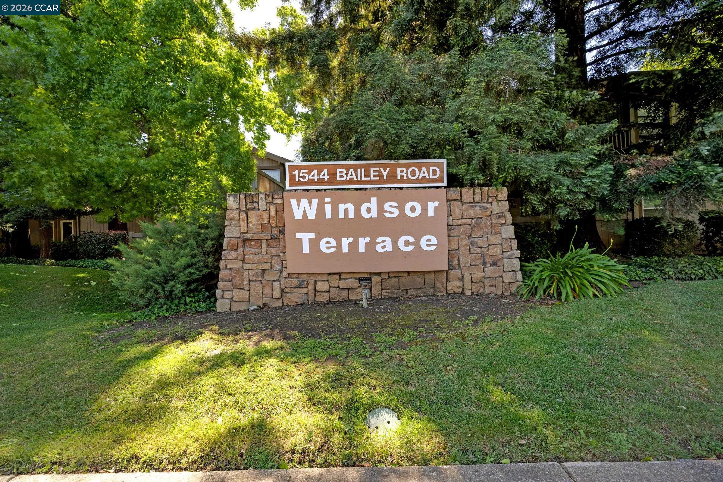 1544 Bailey Road, Unit 30 Concord, CA 94521 - Photo 1 of 33 a sign of golf club on a wall under a tree