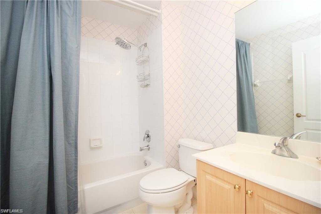 2925 Cypress Trace Circle, Unit 201 Naples, FL 34119 - Photo 11 of 50 a bathroom with a sink a toilet and shower