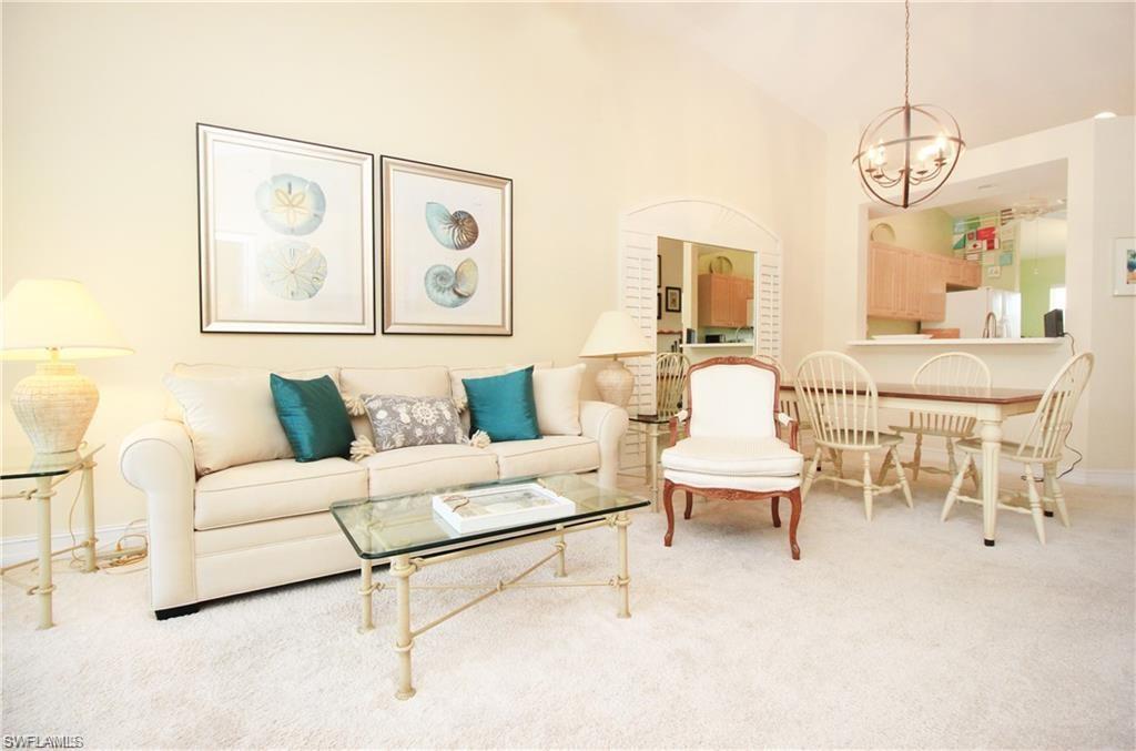 2925 Cypress Trace Circle, Unit 201 Naples, FL 34119 - Photo 13 of 50 a living room with furniture and a large window