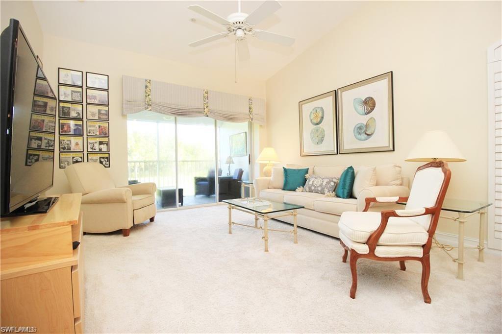 2925 Cypress Trace Circle, Unit 201 Naples, FL 34119 - Photo 15 of 50 a living room with furniture and a large window