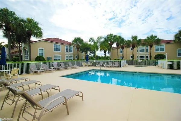 an outdoor view of house with swimming pool and seating