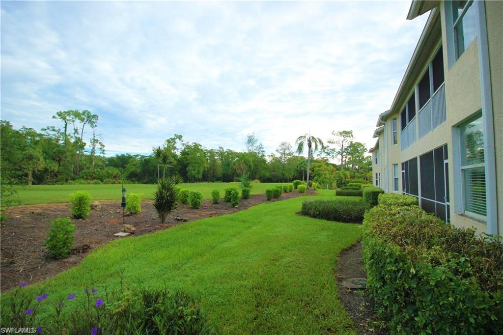 2925 Cypress Trace Circle, Unit 201 Naples, FL 34119 - Photo 18 of 50 a view of a garden with large trees