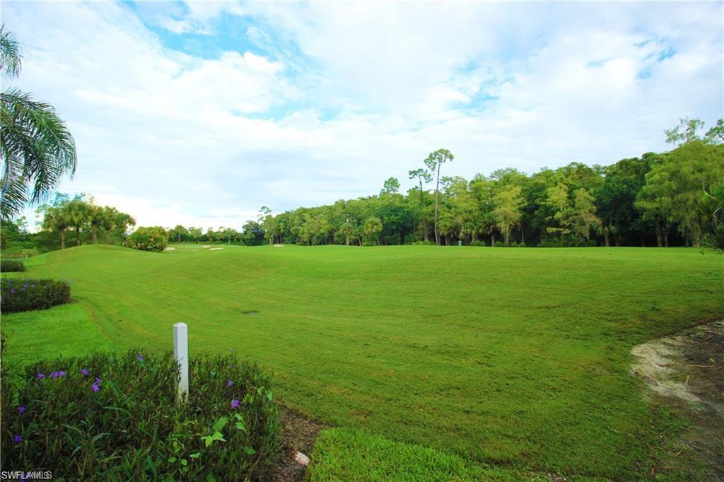 2925 Cypress Trace Circle, Unit 201 Naples, FL 34119 - Photo 19 of 50 a view of a grassy field with plants