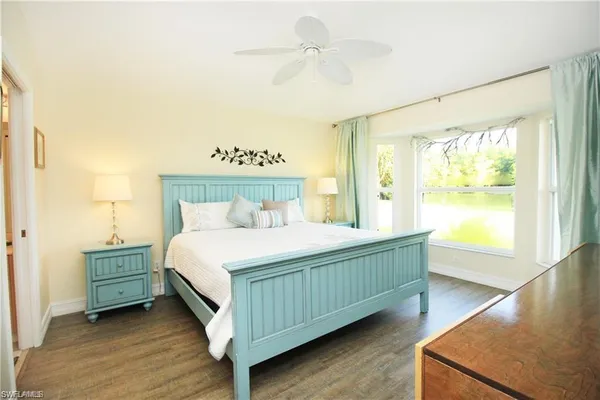 a bedroom with a bed and window