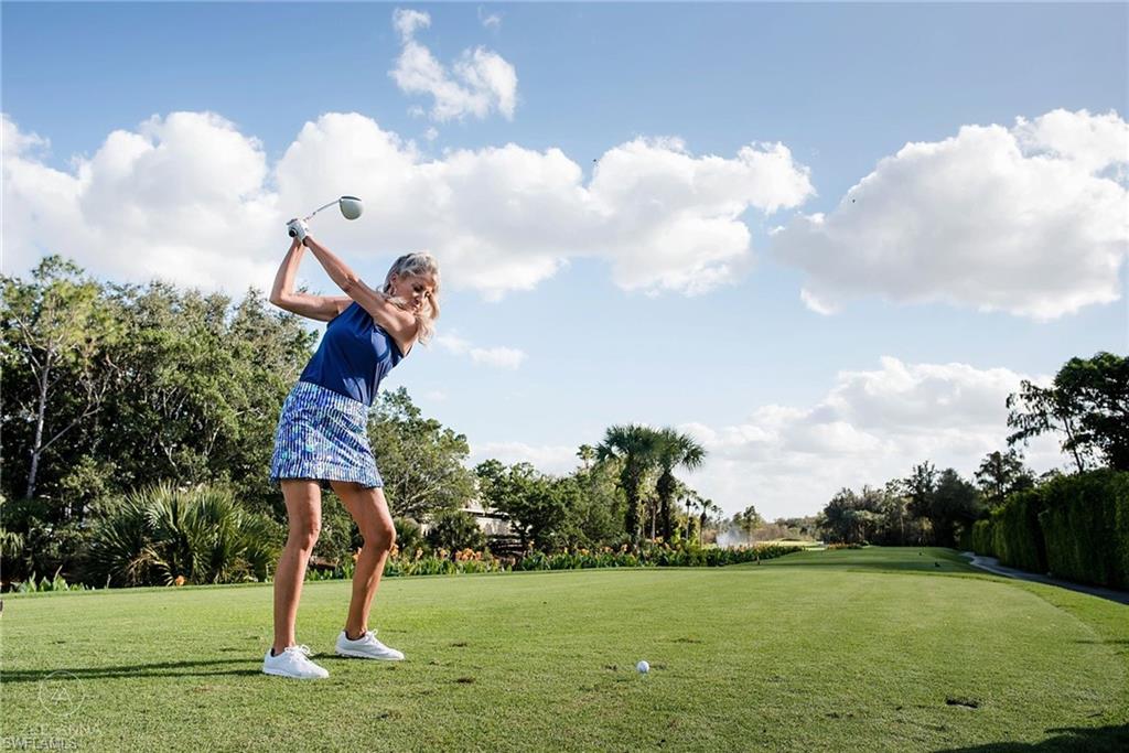 2925 Cypress Trace Circle, Unit 201 Naples, FL 34119 - Photo 39 of 50 a front view of a house with a yard