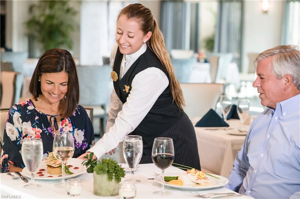 2925 Cypress Trace Circle, Unit 201 Naples, FL 34119 - Photo 46 of 50 a vase of flowers sitting on a table with a fireplace