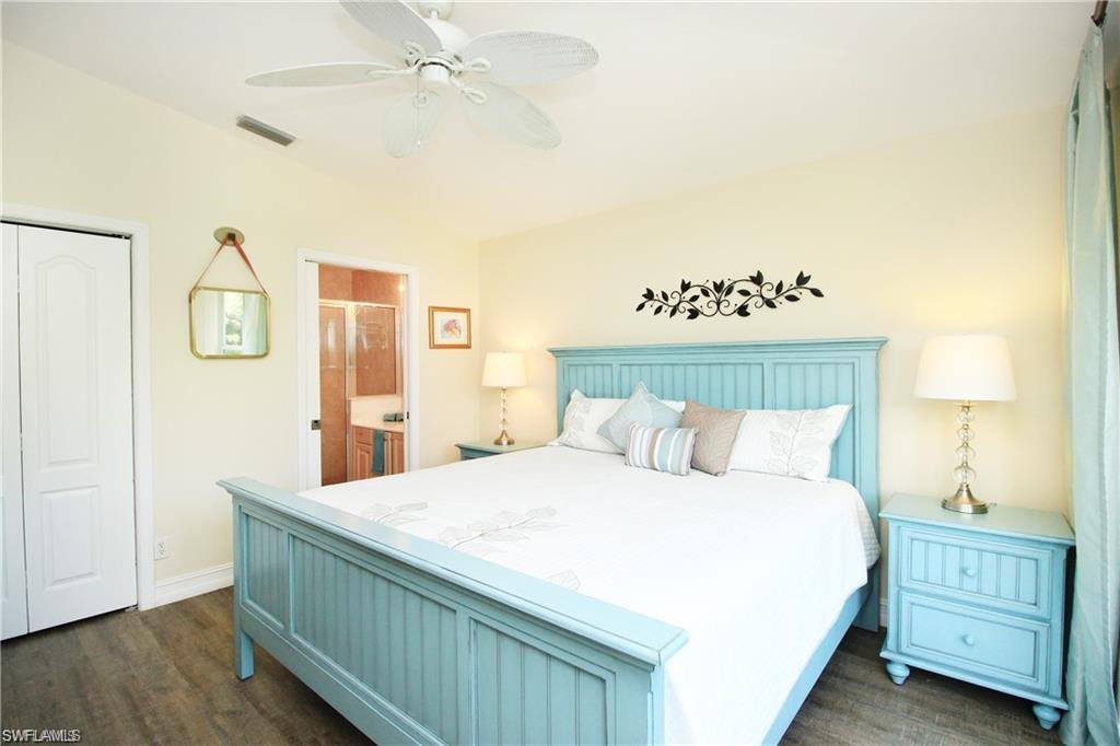 2925 Cypress Trace Circle, Unit 201 Naples, FL 34119 - Photo 7 of 50 a bedroom with a bed and a closet