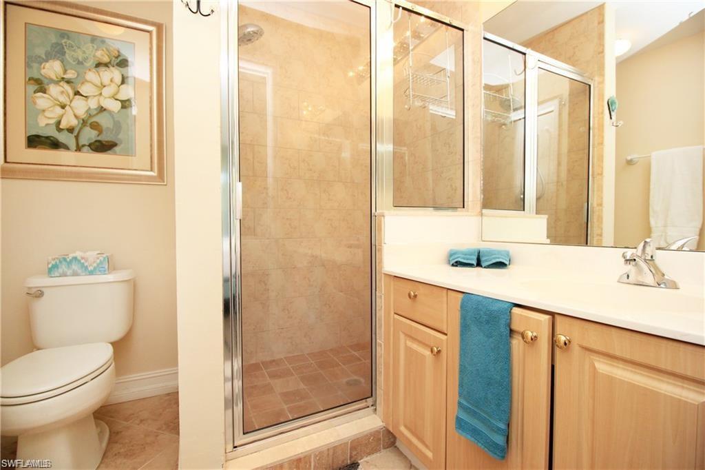2925 Cypress Trace Circle, Unit 201 Naples, FL 34119 - Photo 8 of 50 a bathroom with a sink a toilet and shower