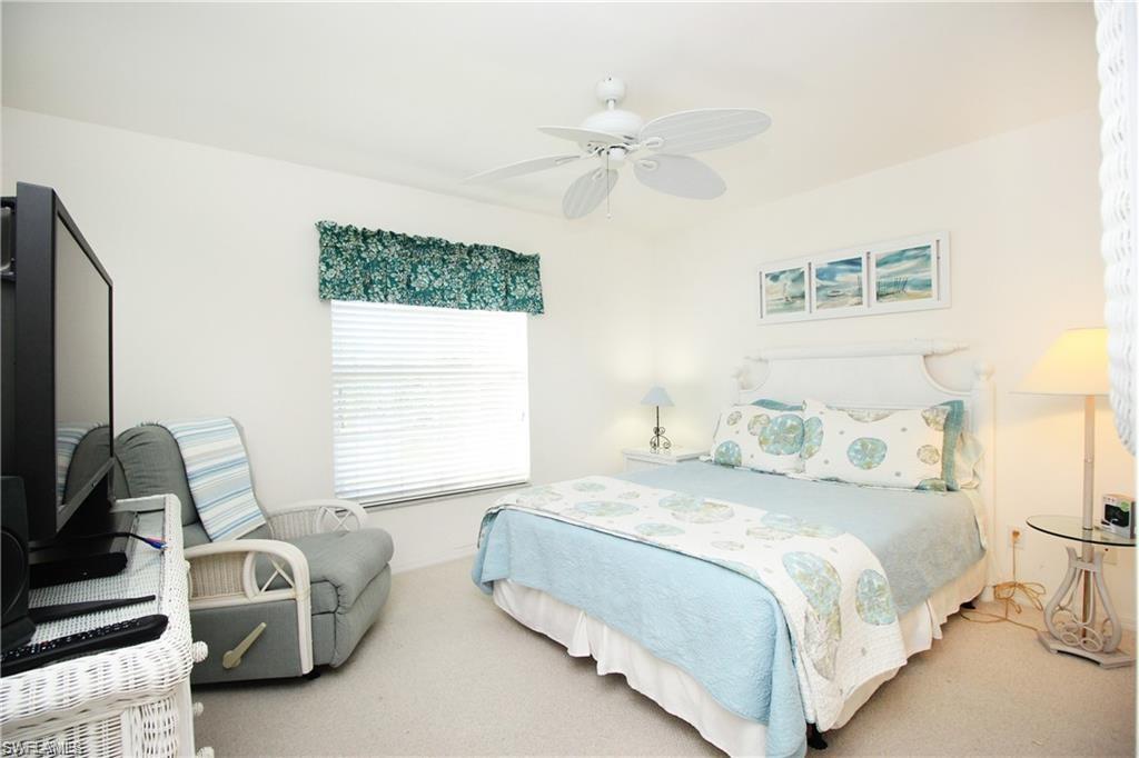 2925 Cypress Trace Circle, Unit 201 Naples, FL 34119 - Photo 9 of 50 a bedroom with a bed furniture and a window